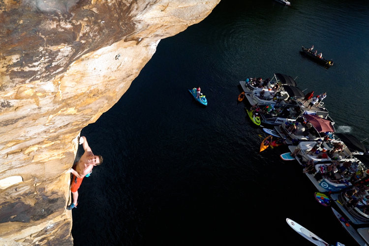 Dru-Mack-climbing-over-water-with-boats-in-harbor Dru-Mack-climbing-over-water-with-boats-in-harbor